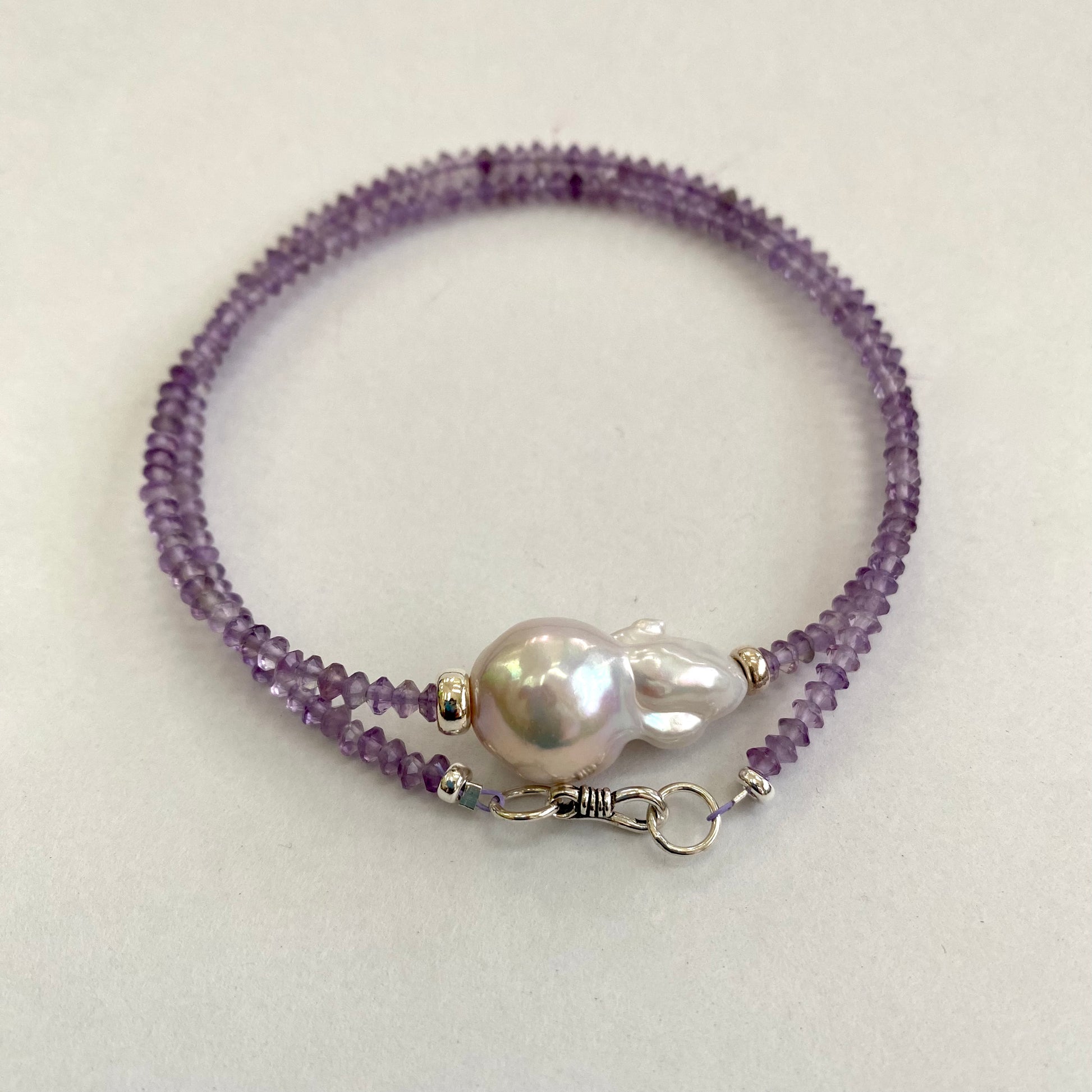 Lavender amethyst baroque pearl necklace featuring a luminous Baroque pearl centerpiece and sparkling amethyst beads.