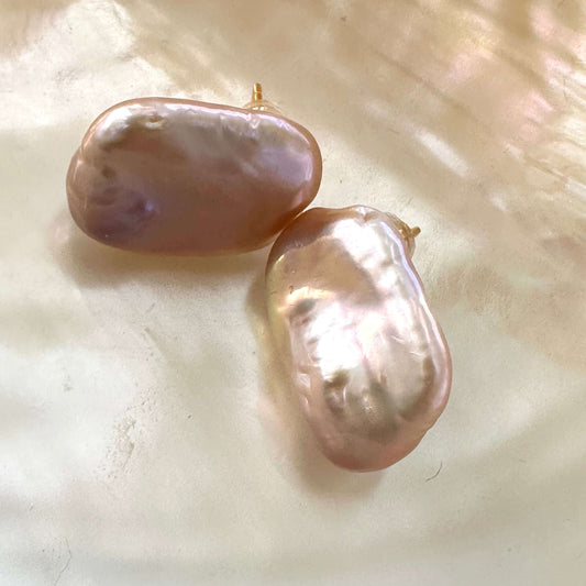 Golden pink rectangle baroque pearl stud earrings displayed on yellow luminescent pearl background, designed and handmade in Canada.