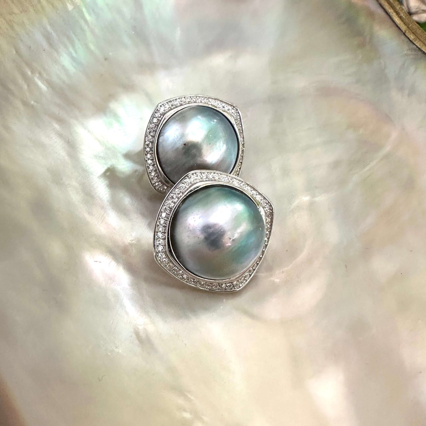 Mabe Pearl Earrings – close-up against white pearl shell backdrop
