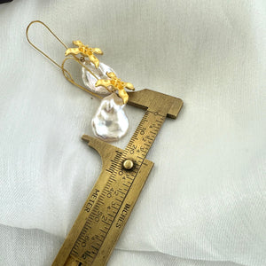 Large Petal pearls dangling gracefully from gold vermeil-plated silver fish hook settings in the shape of flowers, 50mm