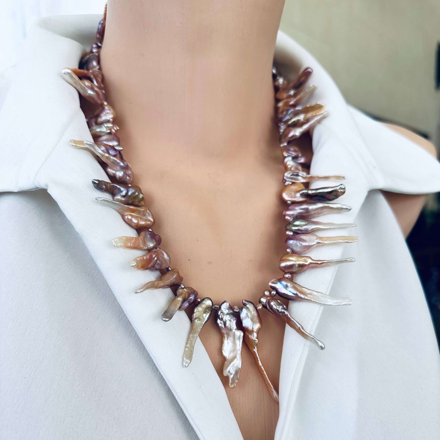 Pink Biwa pearl necklace displayed on mannequin neck, elegant handmade style