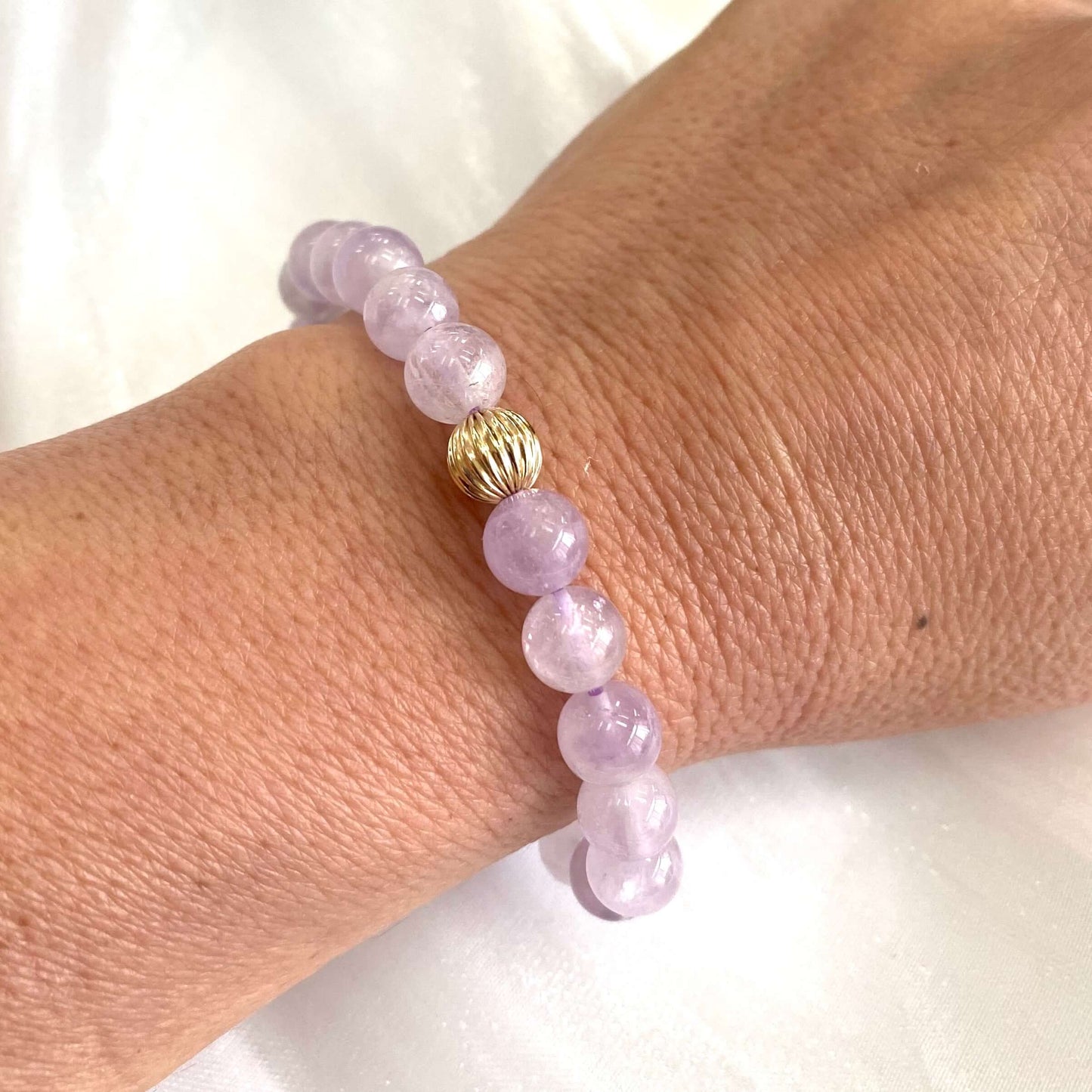 Lavender amethyst stretch bracelet featuring 6mm and 8mm beads, adorned with a 14K gold filled accent.