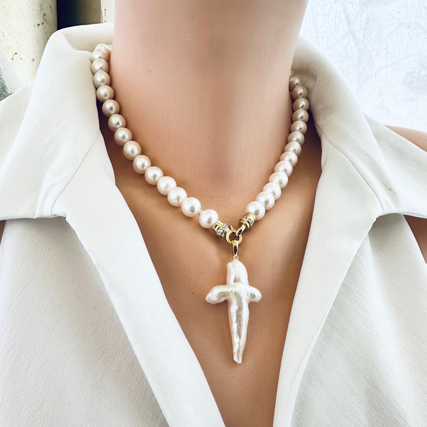 Front view of white pearl necklace cross pendant on mannequin — handcrafted pearl necklace with optional pendant by Loulia Pearl Jewelry