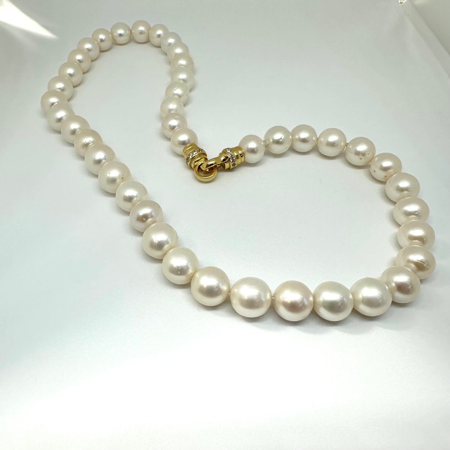 Detailed view of white pearl necklace cross pendant without pendant — fine freshwater pearls with gold or silver clasp