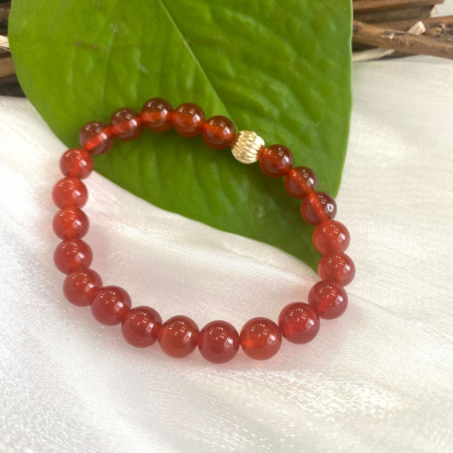 Orange Carnelian Bracelet close-up on white cloth – gold filled accents
