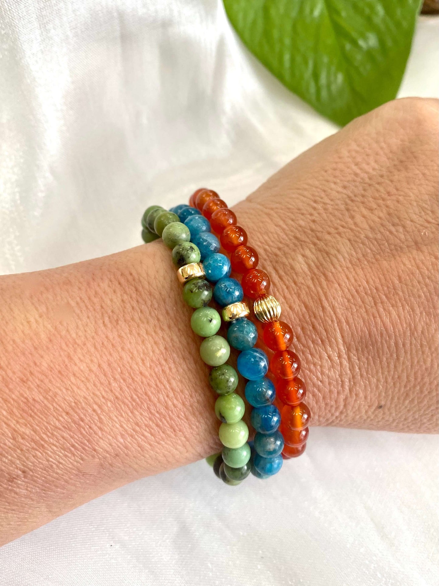Chrysoprase stretch bracelet and colorful bead bracelets worn on wrist, showcasing 6mm beads in vibrant colors.
