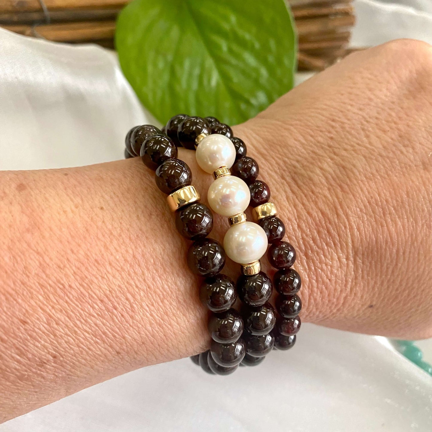Dark Red Garnet Bracelet worn on model’s wrist – stacked trio lifestyle shot