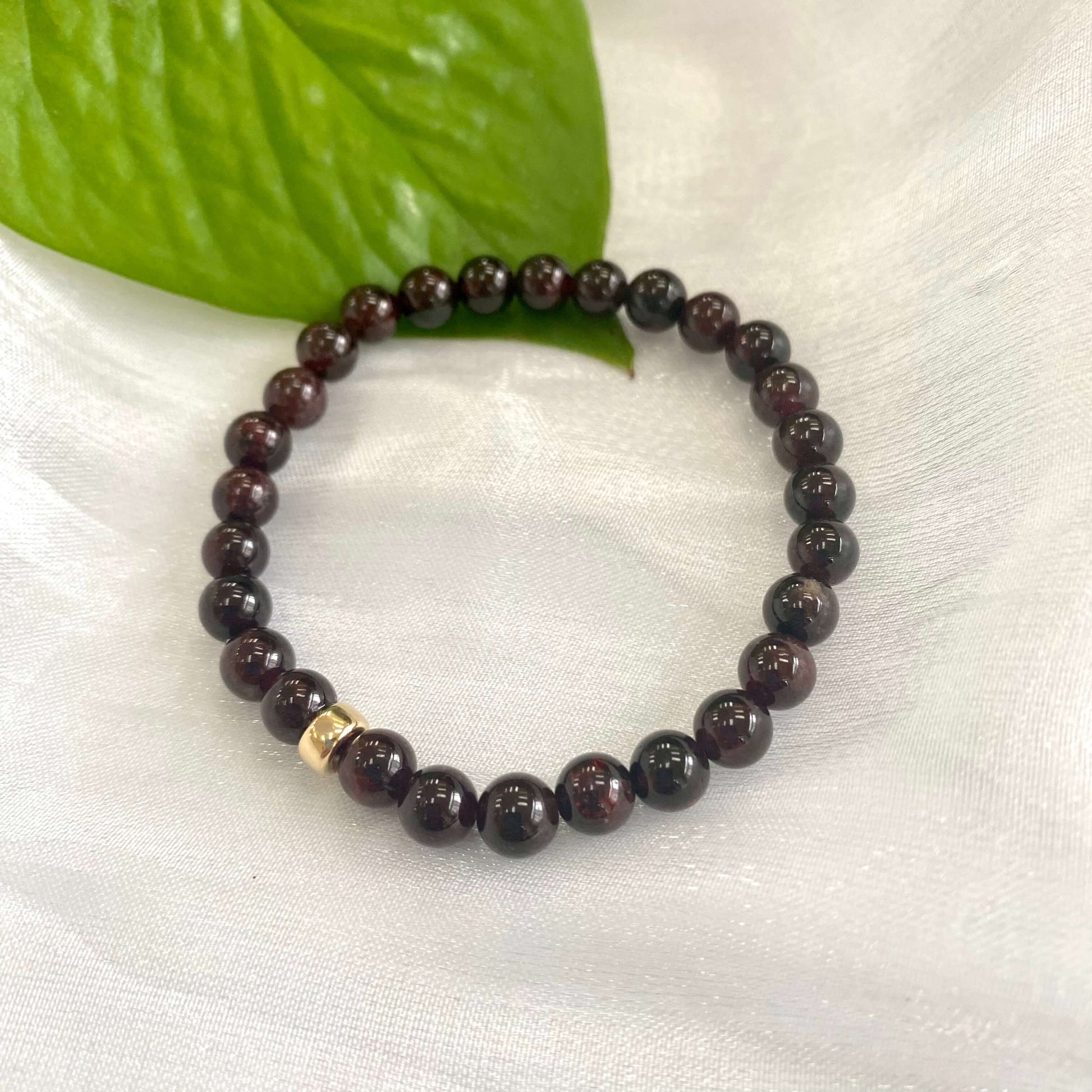 Dark Red Garnet Bracelet close-up on white cloth – single bracelet detail