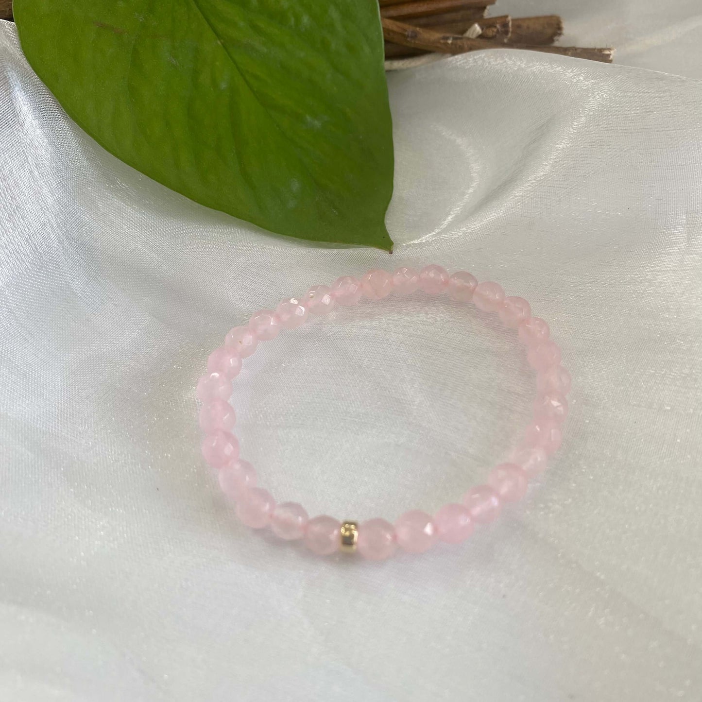 Rose quartz stretch bracelet made with 6mm beads and accented with 14K gold filled, featuring a soft pink color.