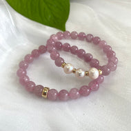 Rose Quartz Pearl Bracelet pair displayed on white cloth – two-bracelet close-up