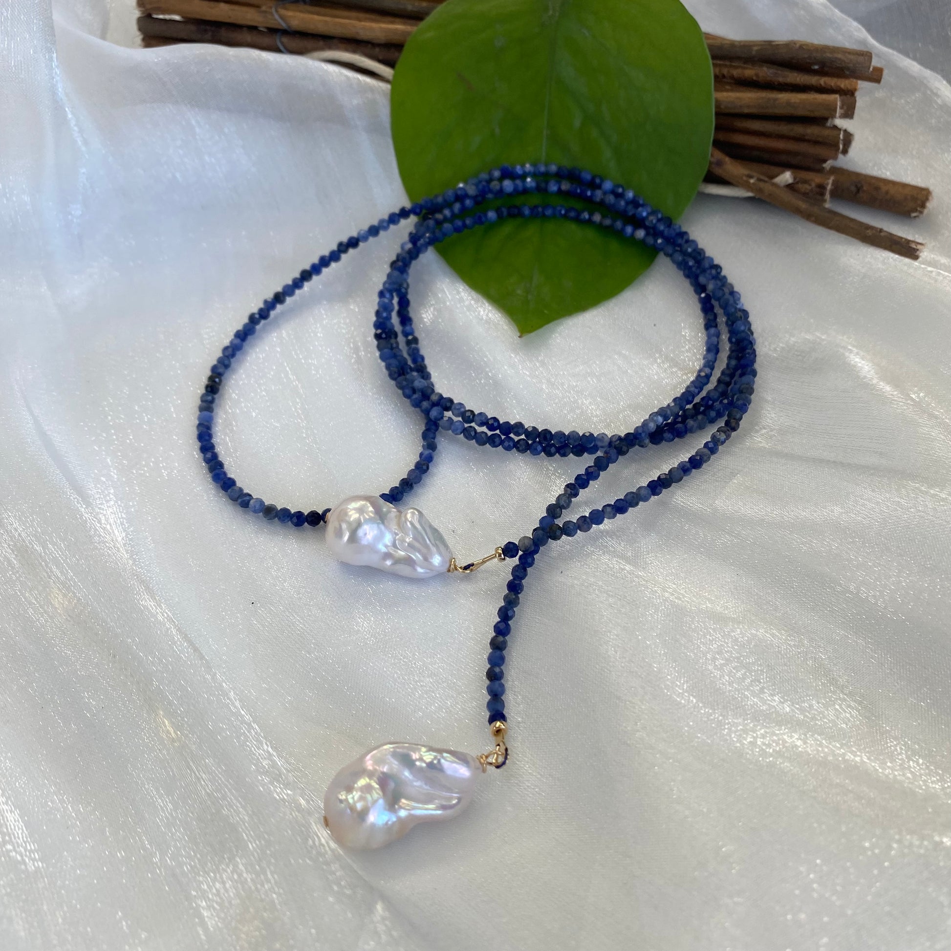 Sodalite baroque pearl lariat necklace displayed flat highlighting blue sodalite beads and pearls