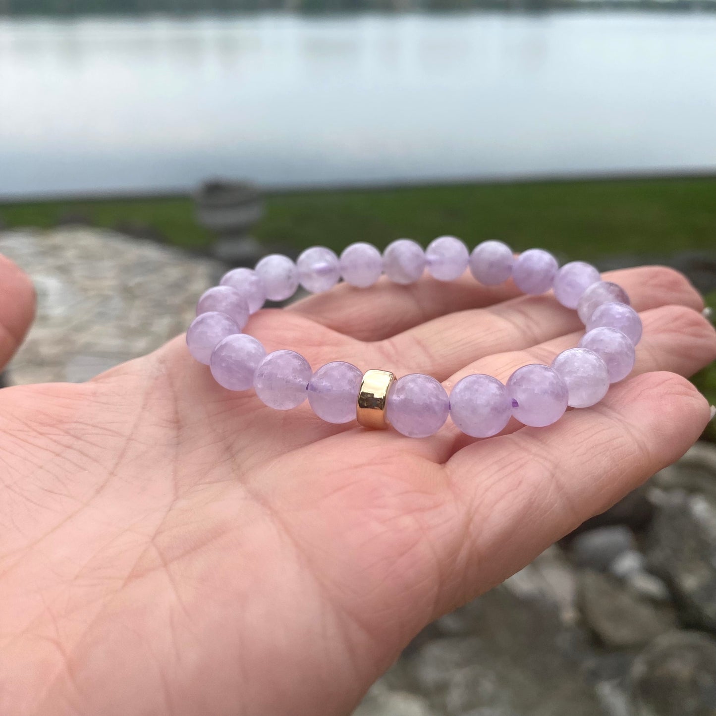 Lavender Amethyst Bracelet shown in hand with lake backdrop – natural light