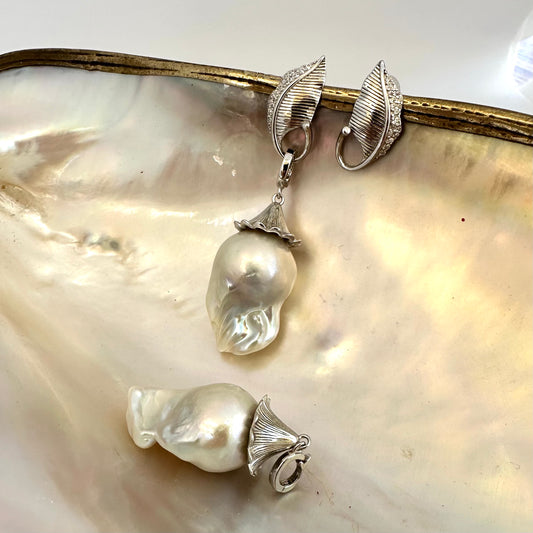 Close-up of Leaf Design Baroque Pearl Earrings on white pearl backdrop — sterling silver and genuine baroque pearls handcrafted by Loulia Pearl Jewelry