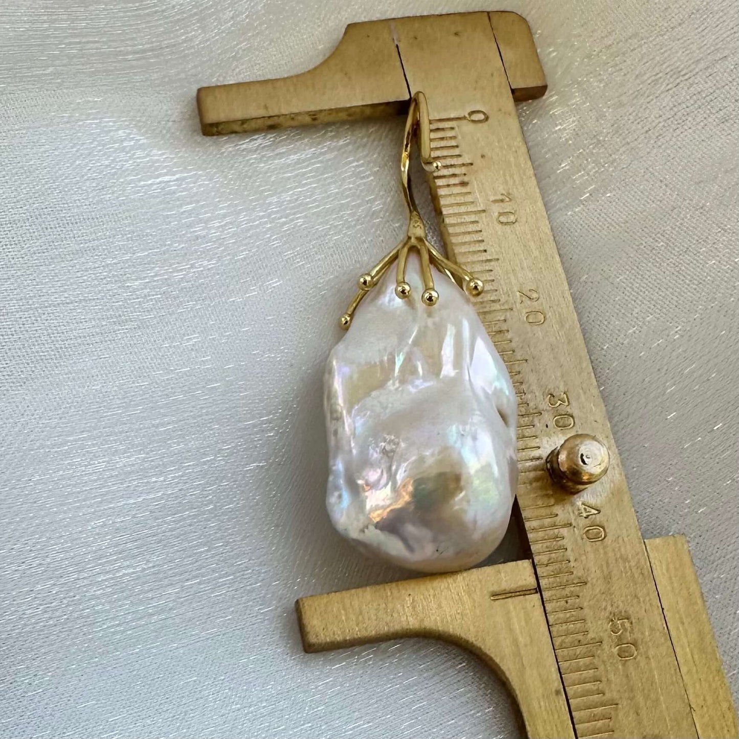 Baroque pearl drop earring size comparison with ruler, white freshwater pearls shown in detail