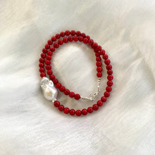 Load image into Gallery viewer, red coral and one large baroque pearl on the side of the necklace with sterling silver details, measuring 18 inches. This vibrant jewelry piece makes a thoughtful gift for her.

