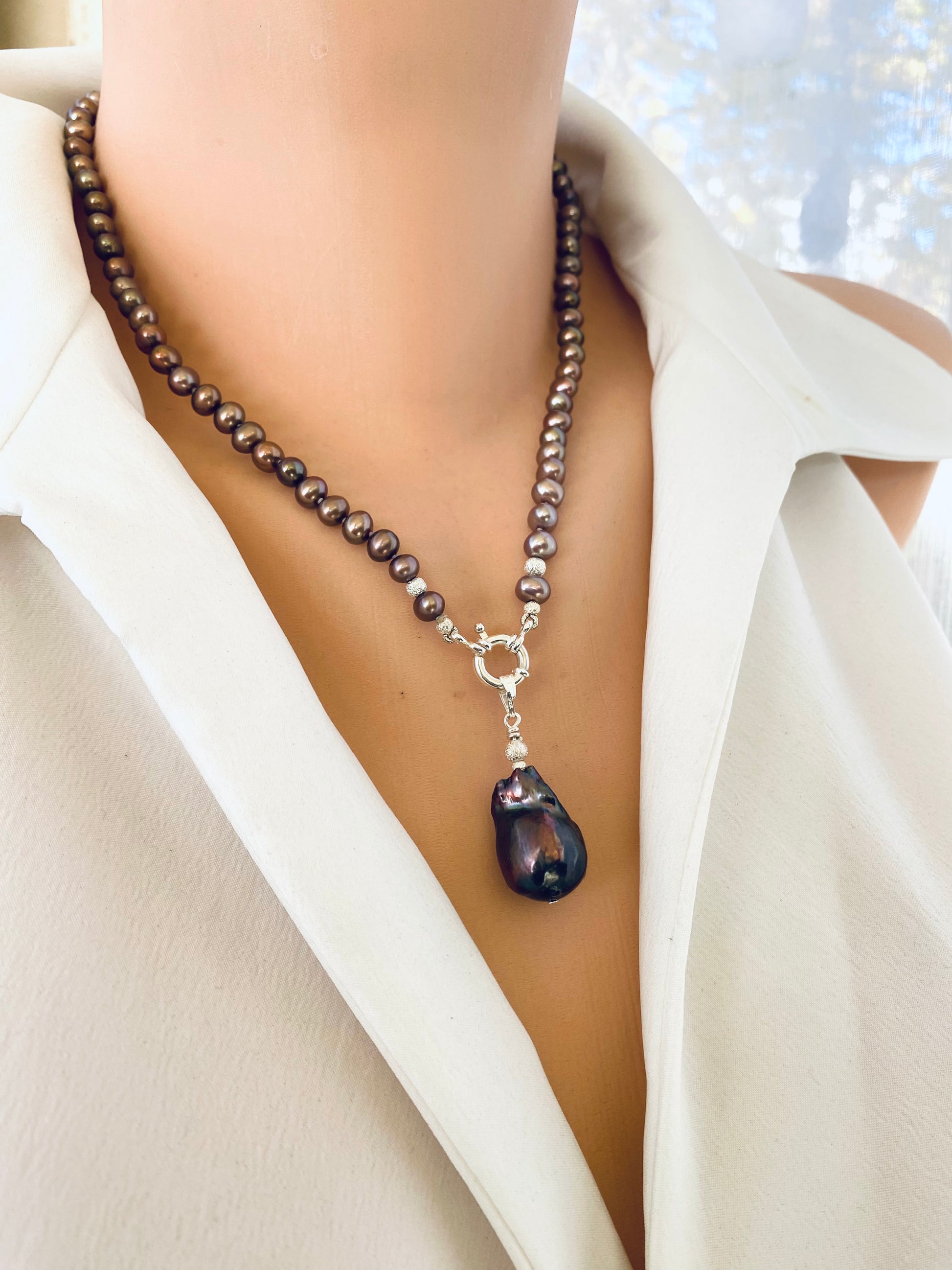 Bronze pearl necklace featuring removable brown baroque pearl pendant, displayed on mannequin with natural luster and sheen.