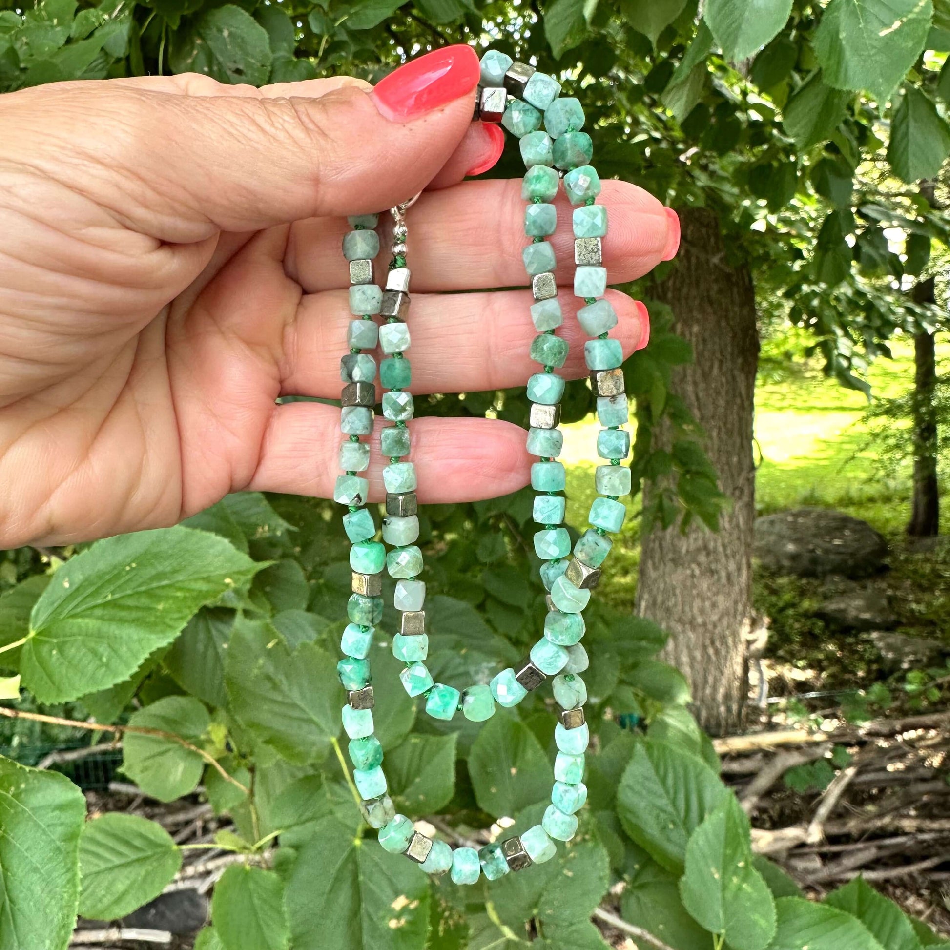Emerald Pyrite Candy Necklace displayed, showcasing handcrafted design with emerald cube-cut gemstones and pyrite.