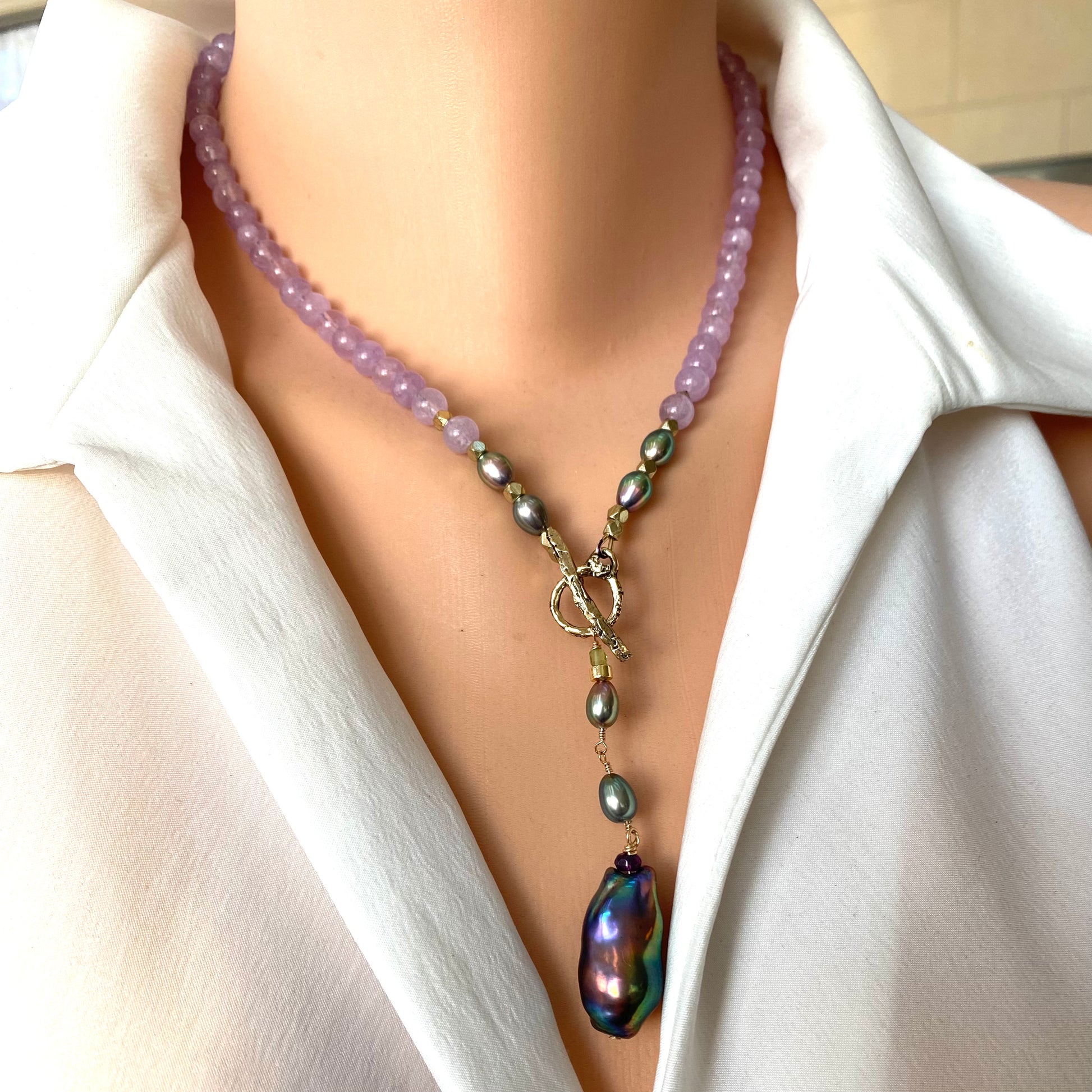 Amethyst Pearl Necklace with lavender amethyst beads and black baroque pearl pendant displayed on mannequin.
