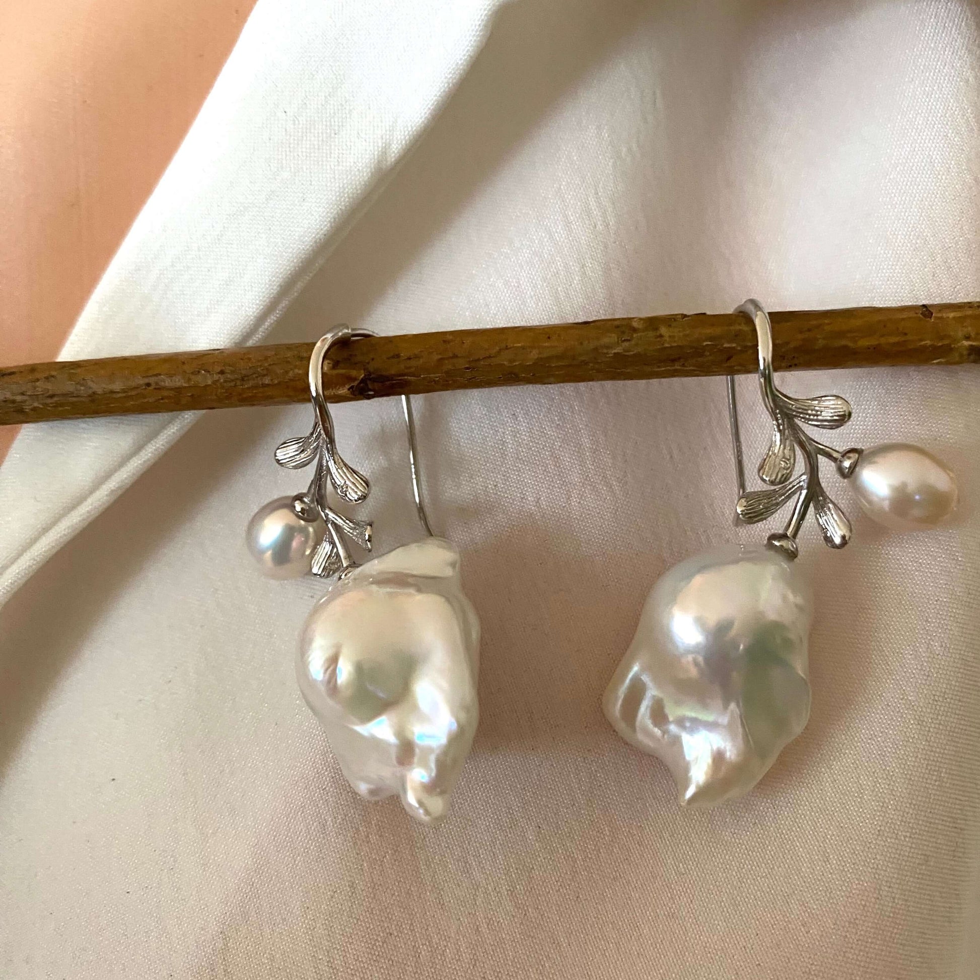 Detailed view of handcrafted baroque pearl earrings in silver, bridal jewelry style