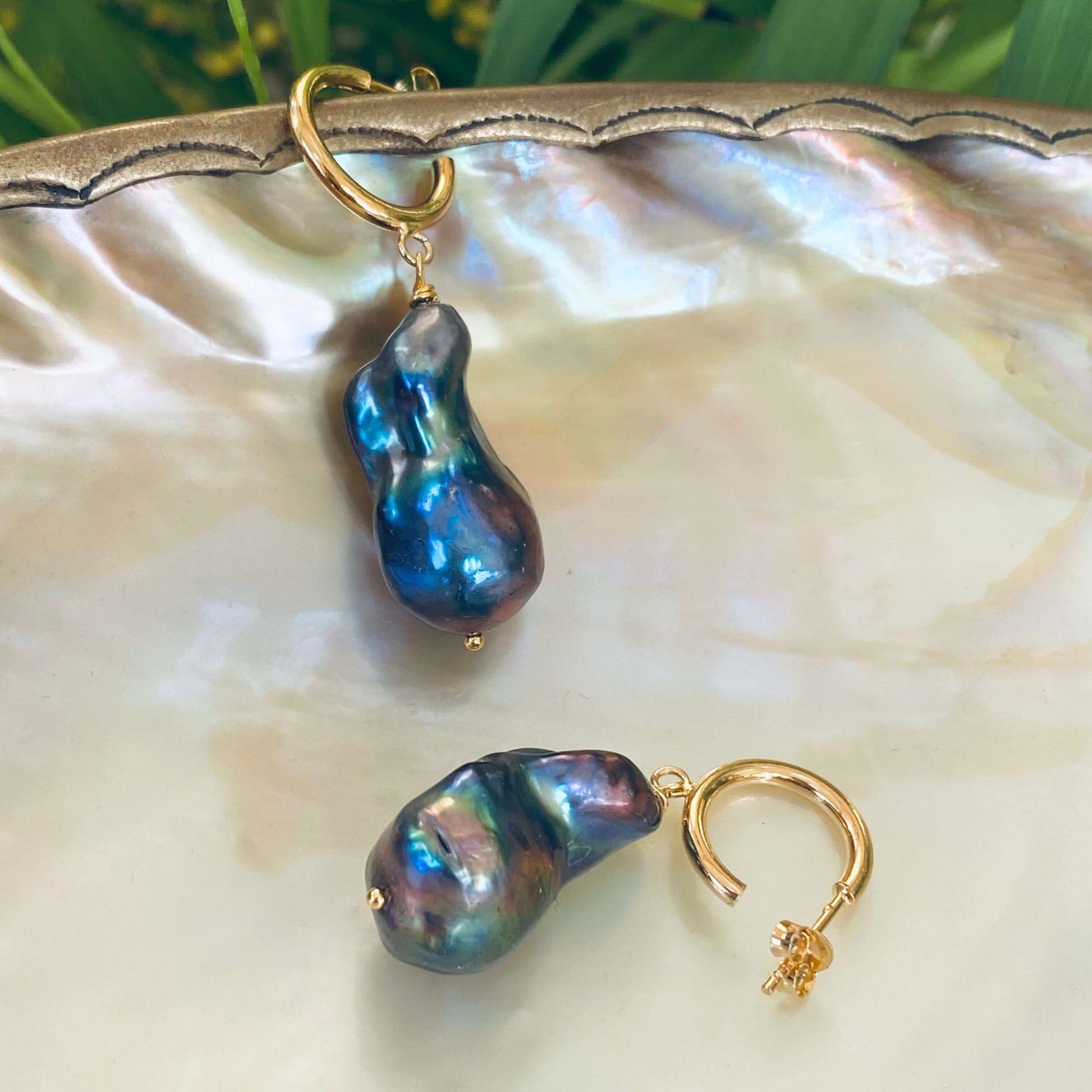 Baroque pearl hoop earrings highlighting iridescent peacock luster and gold vermeil hoops