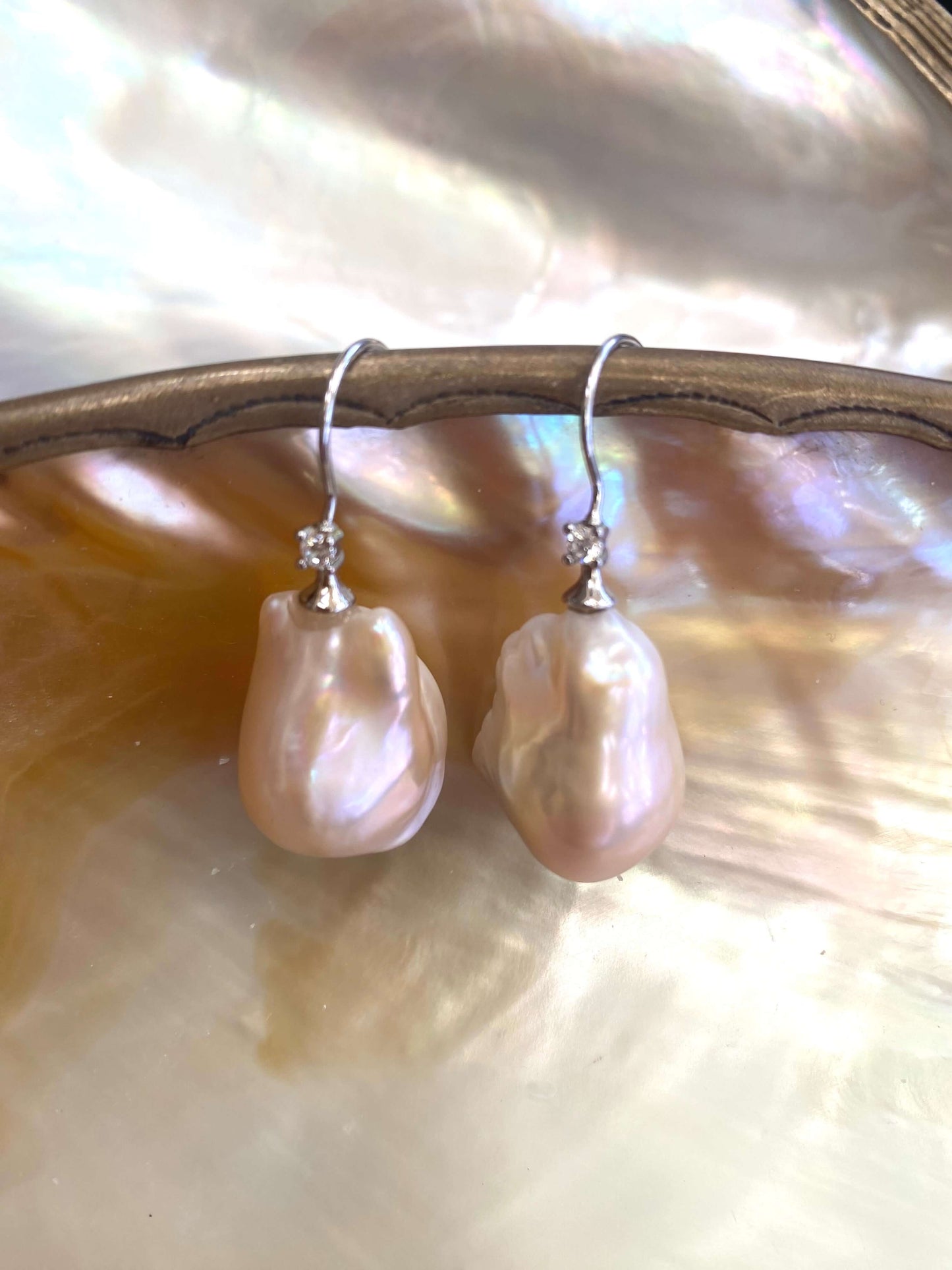 Golden Baroque Pearl Earrings – detailed view on white pearl shell background