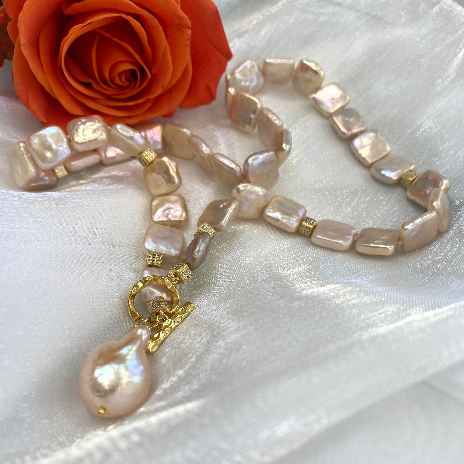 Close-up of golden baroque pearl toggle necklace on white background — CZ pavé gold cube accents and lustrous pearls by Loulia Pearl Jewelry