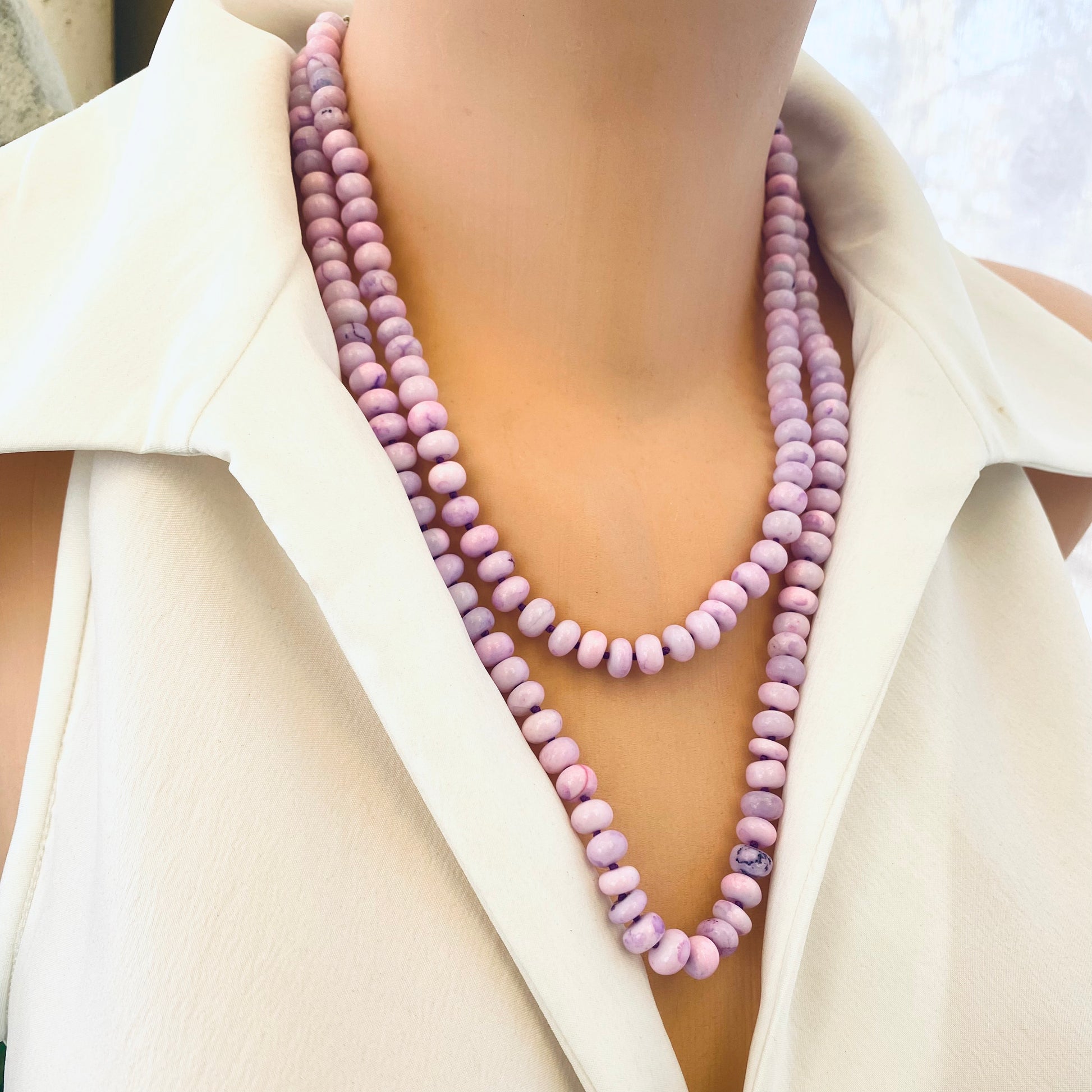 → Hand-knotted lavender opal necklace with pendant shown doubled from side angle on mannequin.