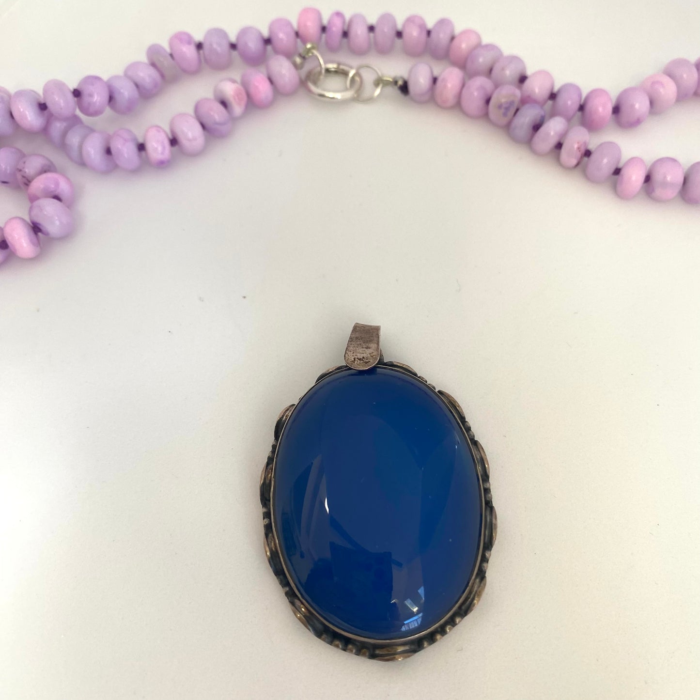 → Blue agate pendant close-up beside lavender opal necklace, natural gemstone jewelry handmade in Canada.
