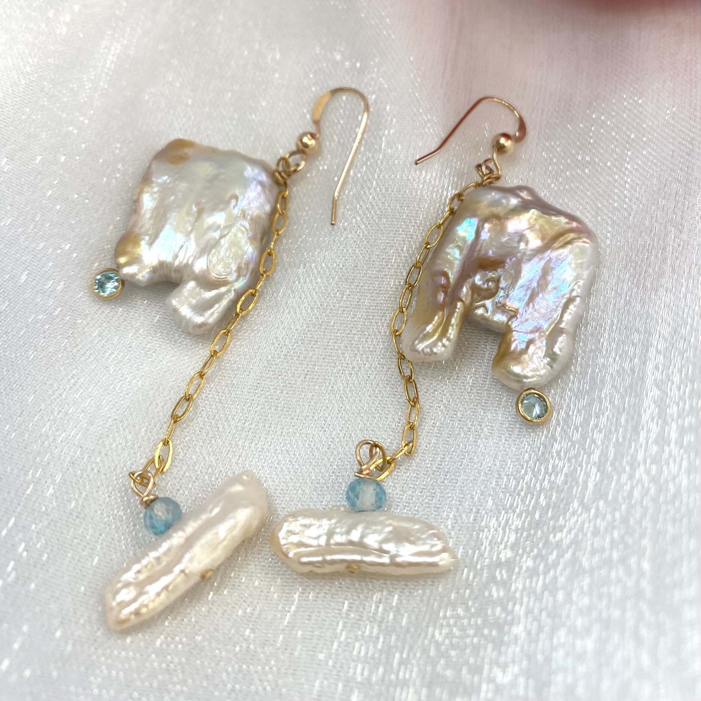 Close-up of boho pearl earrings gold filled on white background — square keshi pearls with blue topaz accents handcrafted in Canada
