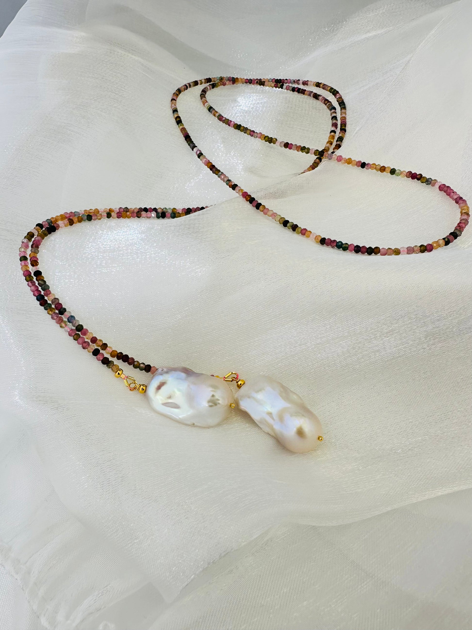 Detailed view of Multi Tourmaline Baroque Pearl Lariat Necklace on white surface — colorful tourmaline and white pearls by Loulia Pearl Jewelry