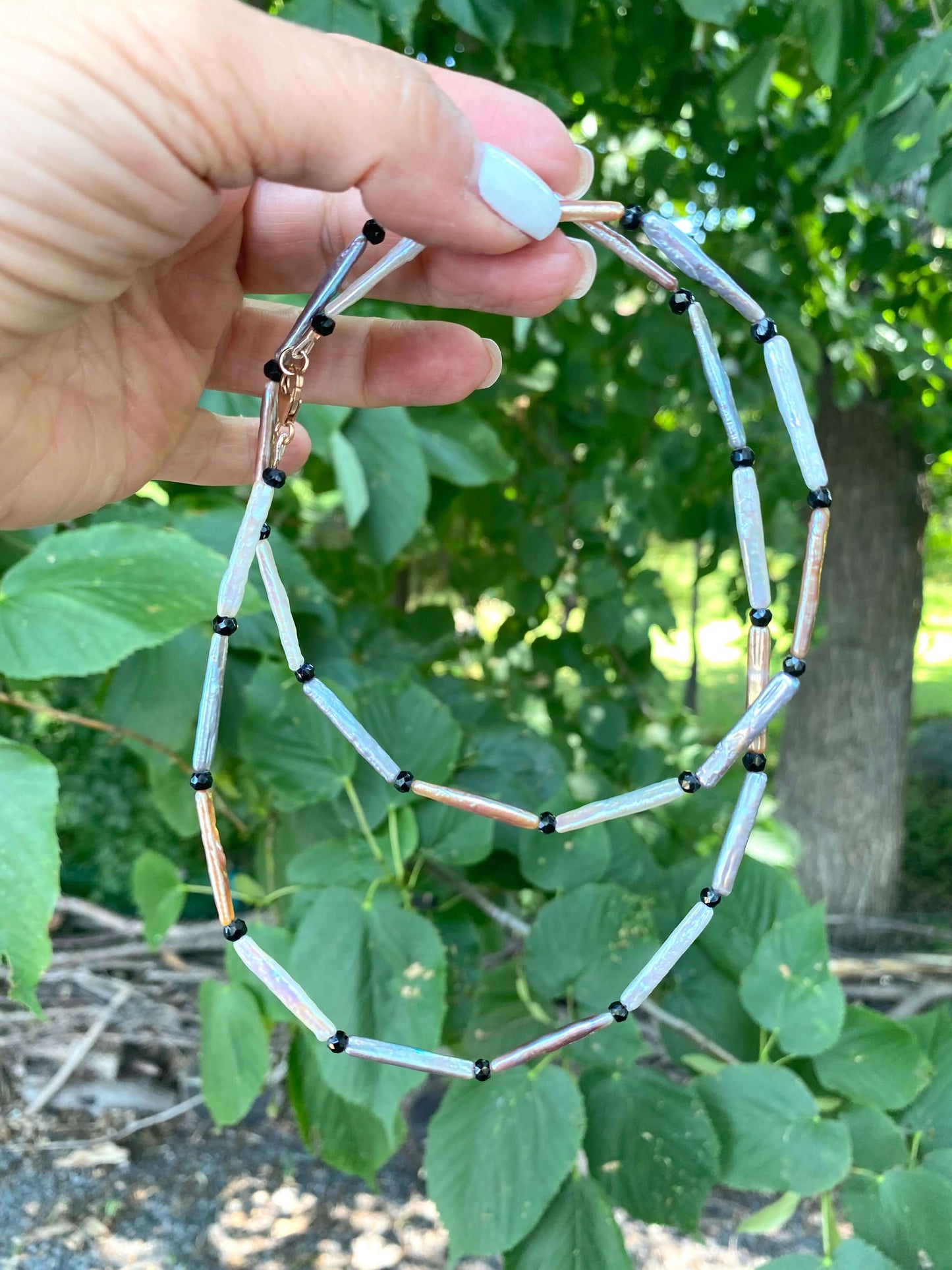 Pastel Stick Pearl Necklace featuring stick pearls in white, blush pink, and soft grey with black spinel accents.