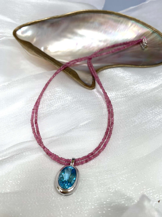 Pink Tourmaline Blue Topaz Pendant on double-strand necklace, showcasing vibrant pink and blue gemstones.