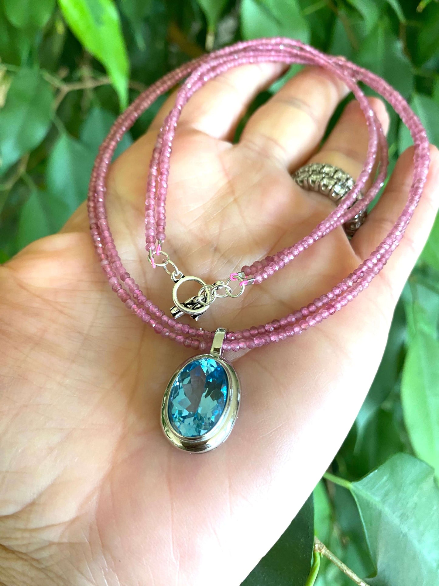 Pink Tourmaline Blue Topaz Pendant showcased in a double-strand design with faceted pink tourmaline beads and blue topaz gemstone.