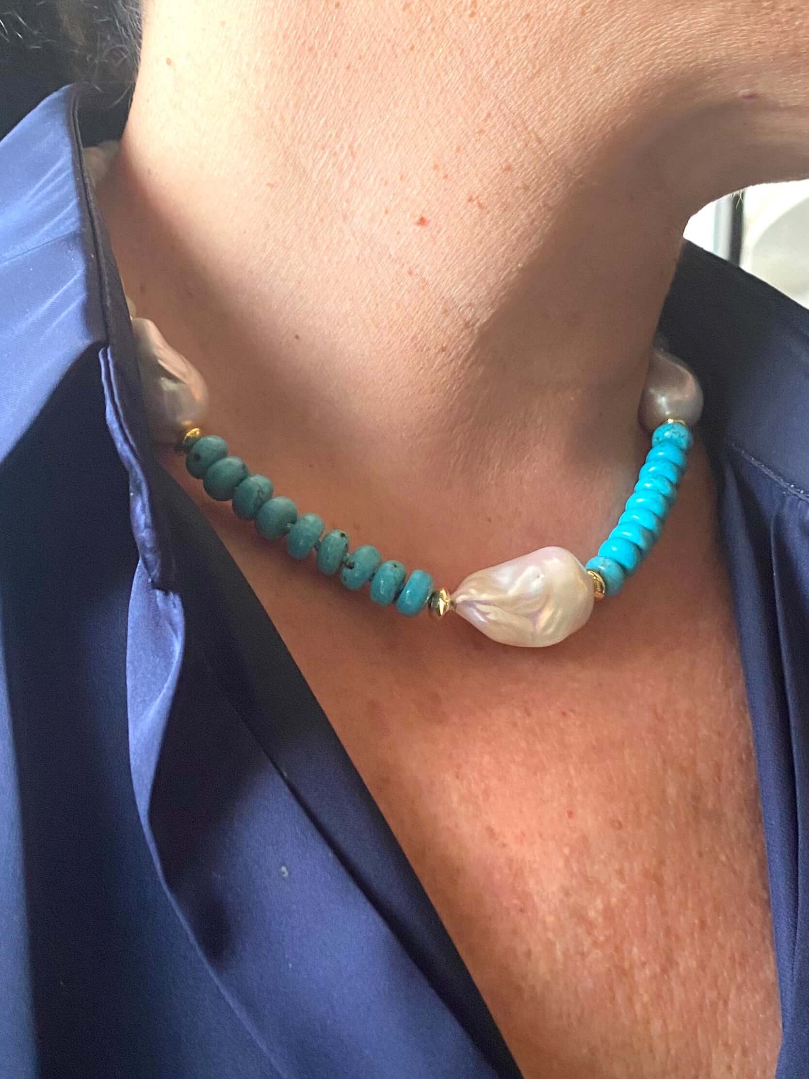 Side view of green jade and turquoise pearl necklace on mannequin display