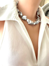 Load image into Gallery viewer, Baroque pearl necklace with silver details, showcasing large silver-grey baroque pearls on a stylish blouse.
