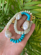 Load image into Gallery viewer, Hand holding green jade and turquoise pearl necklace against leafy backdrop
