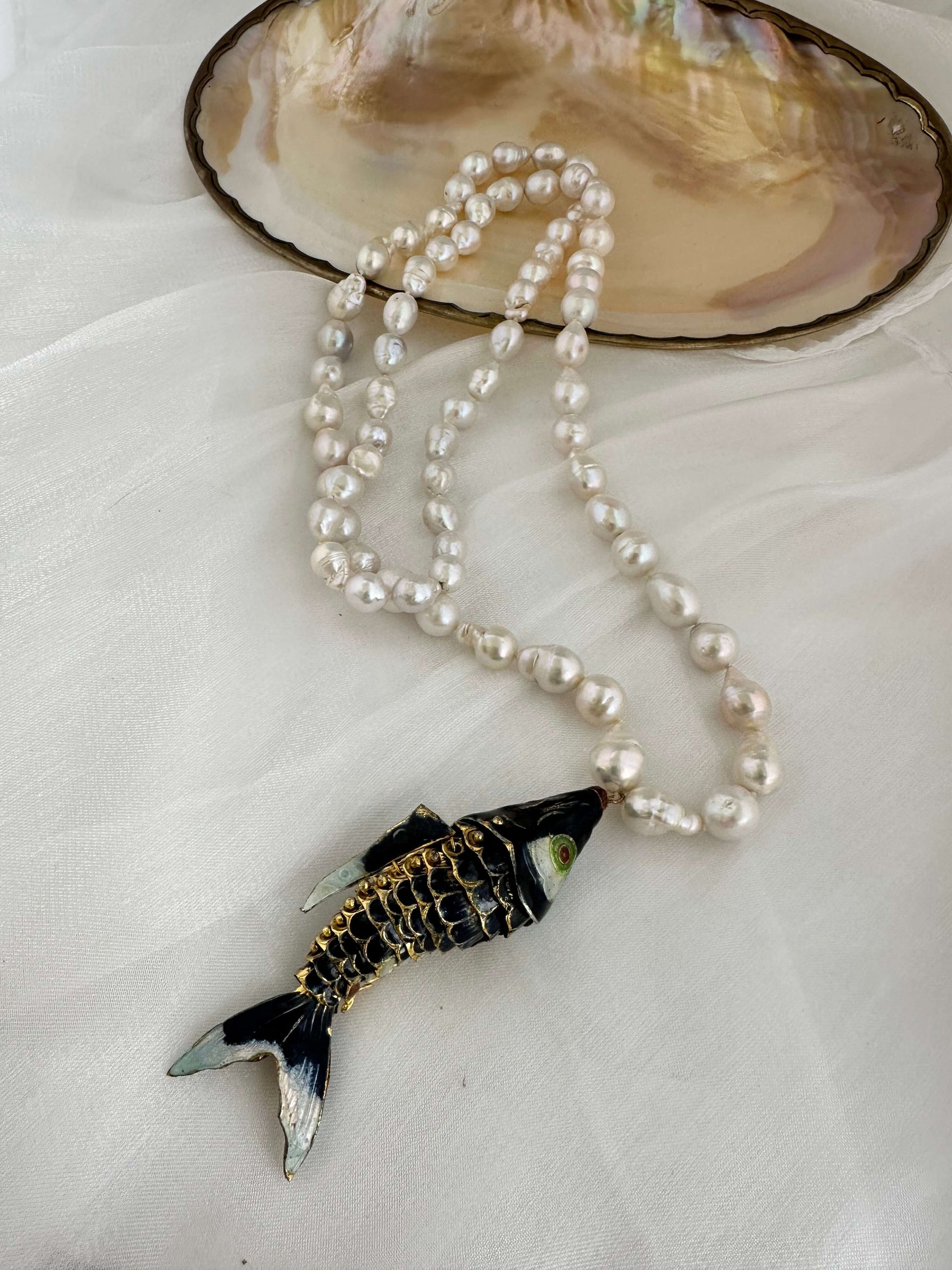 Fish pendant pearl necklace with large black fish pendant and baroque pearls.