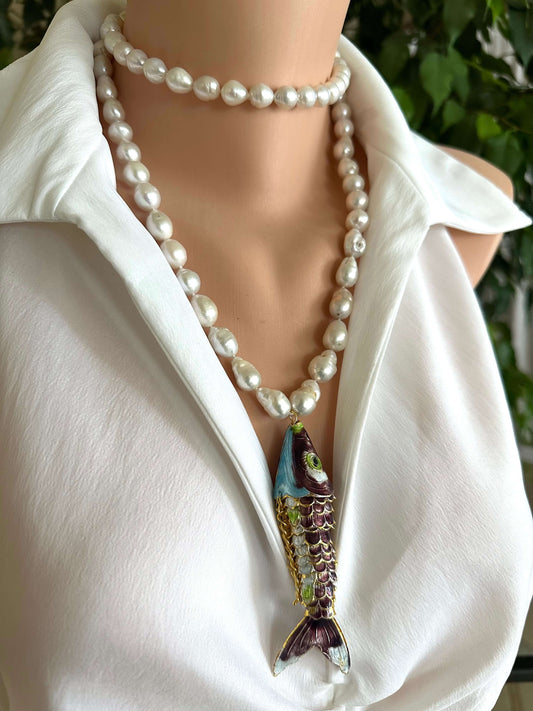 Koi fish pearl necklace with baroque pearls on a mannequin wearing a white shirt.