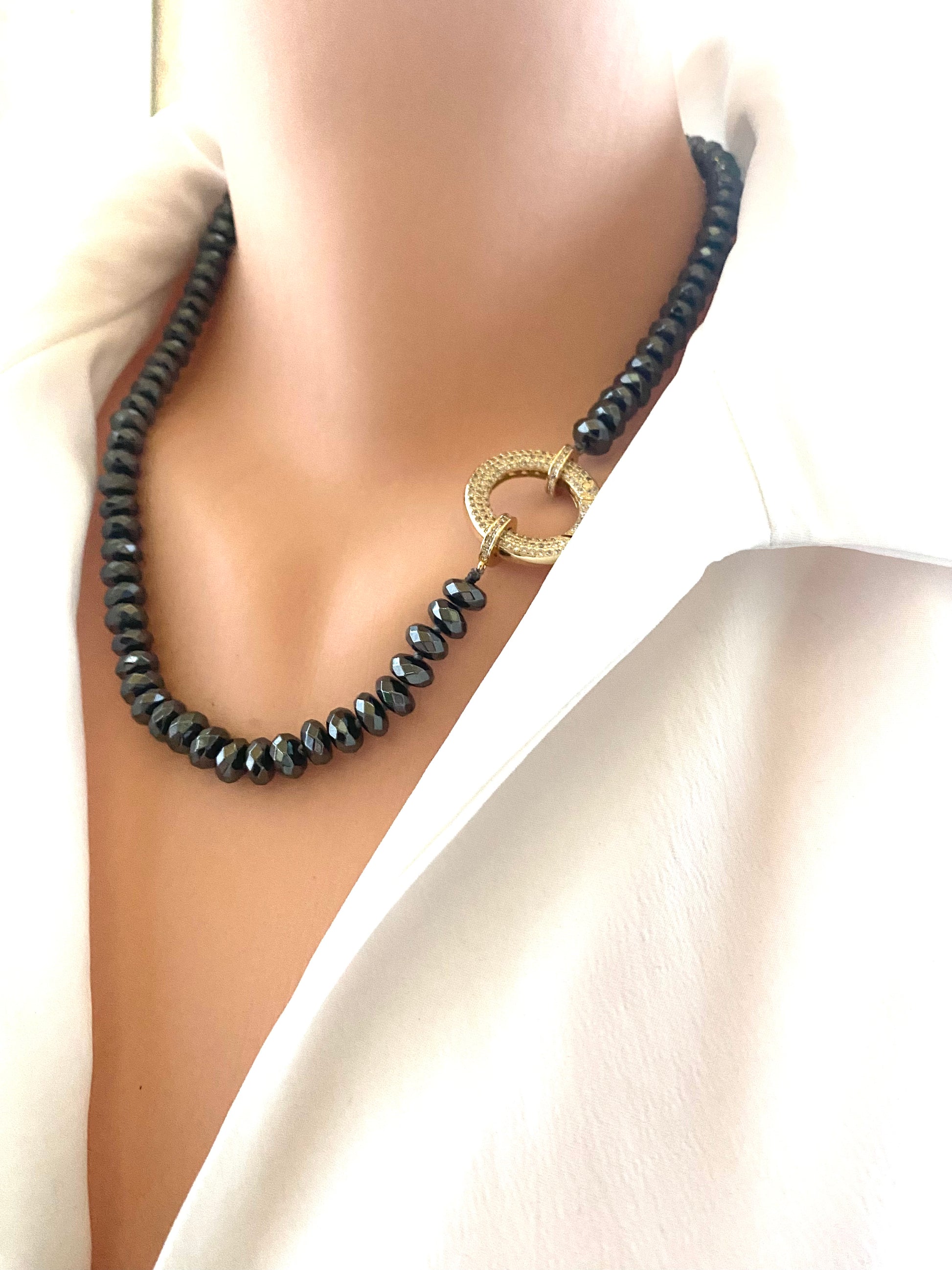 Festive Hematite Necklace featuring dark hematite beads and a unique gold clasp, perfect for statement jewelry lovers.