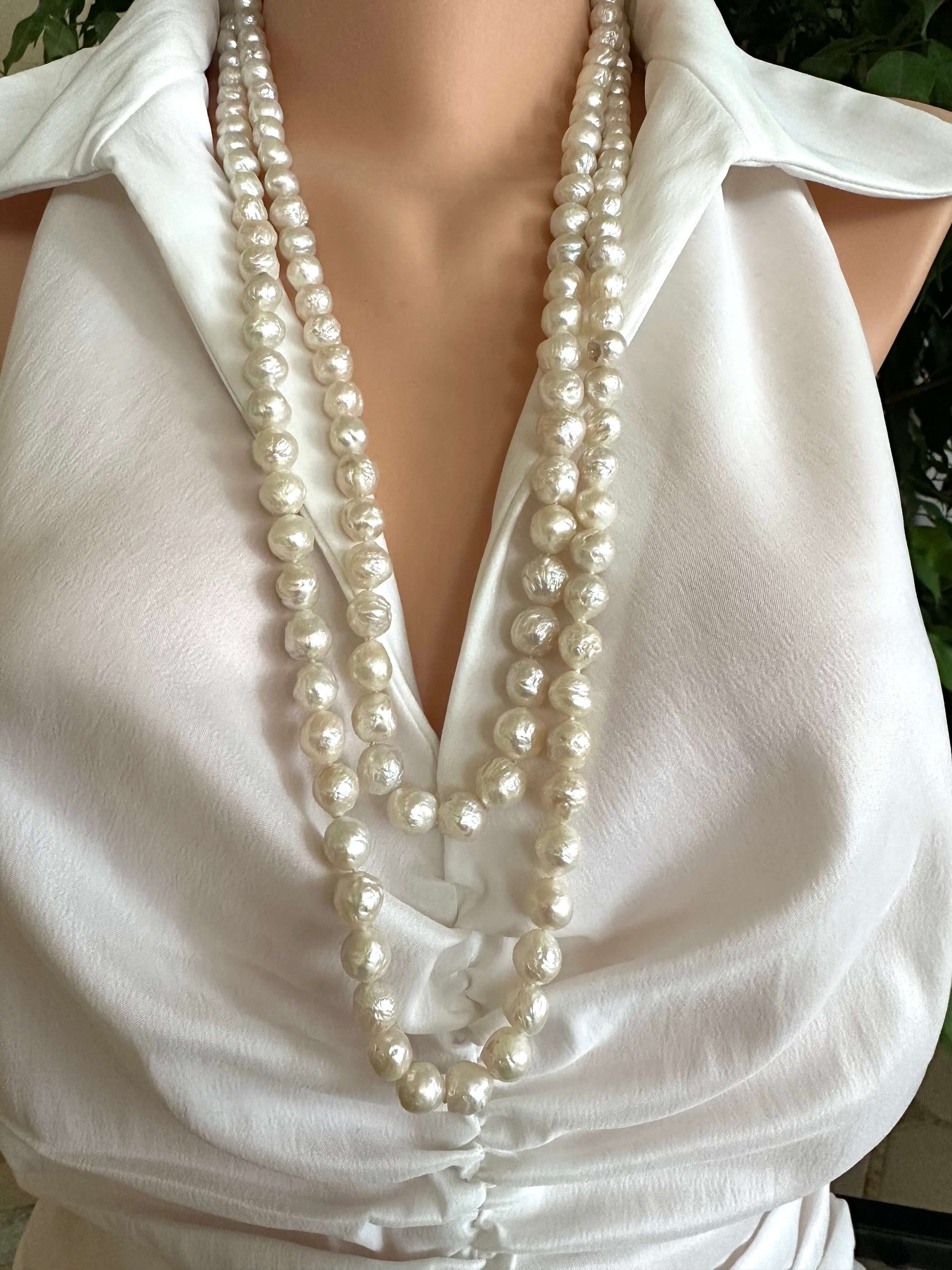 Edison pearl Y necklace featuring handcrafted baroque pearls, styled elegantly on a mannequin.