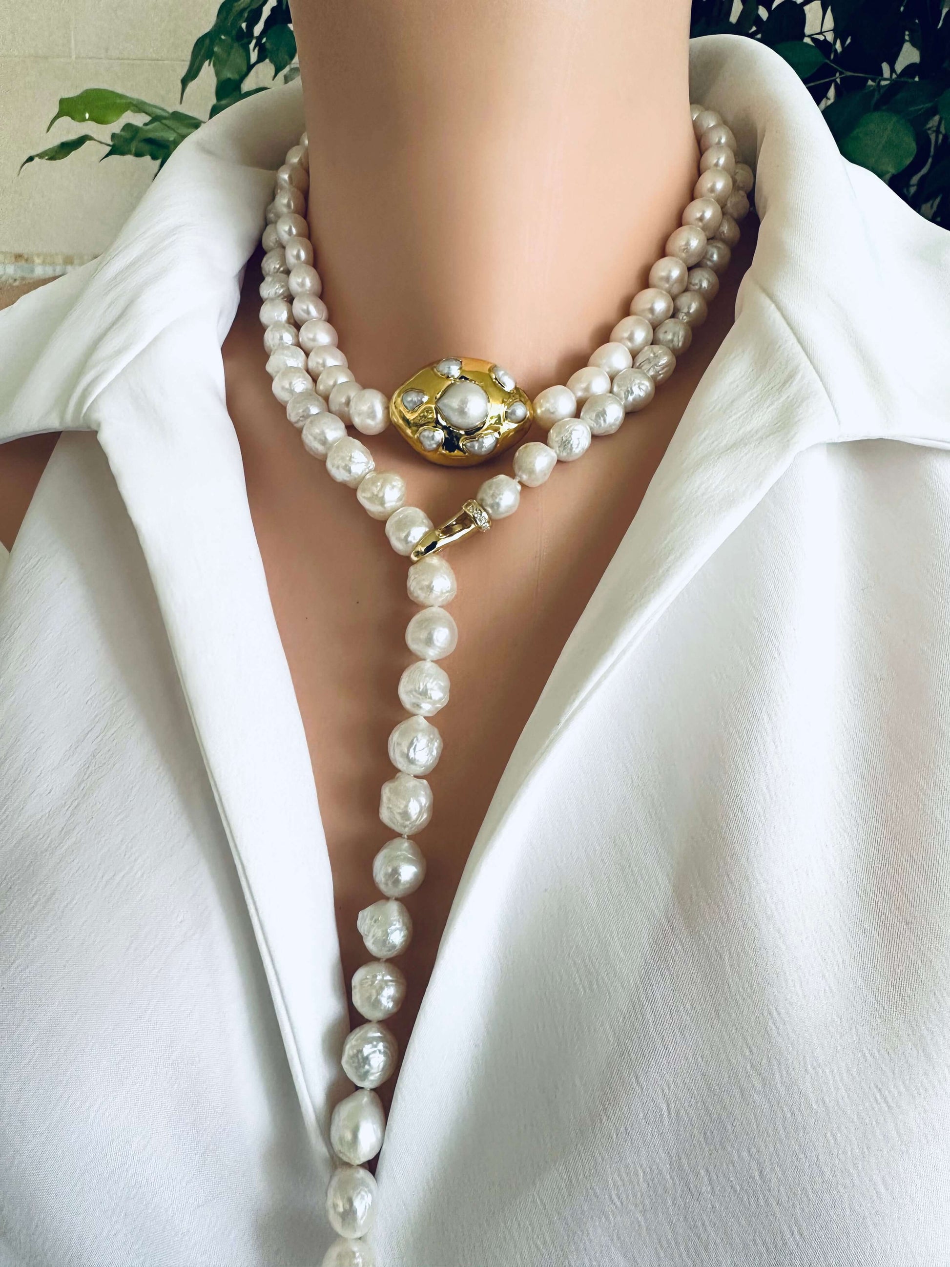Edison pearl Y necklace featuring hand-knotted avocado baroque pearls worn by a model with a white blouse.