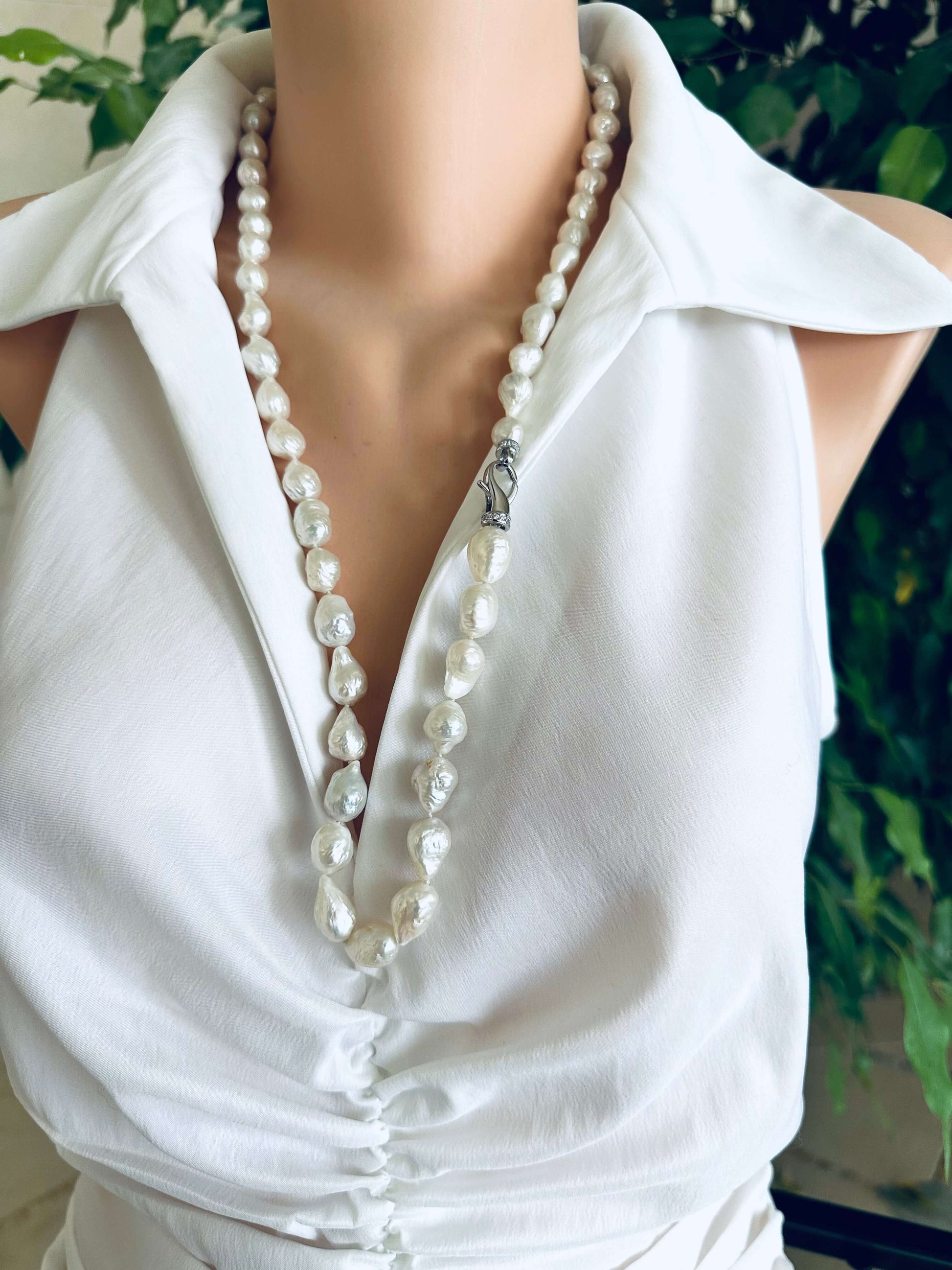 Edison baroque pearl Y necklace displayed on a mannequin, featuring organic baroque shaped pearls and rhodium clasp.