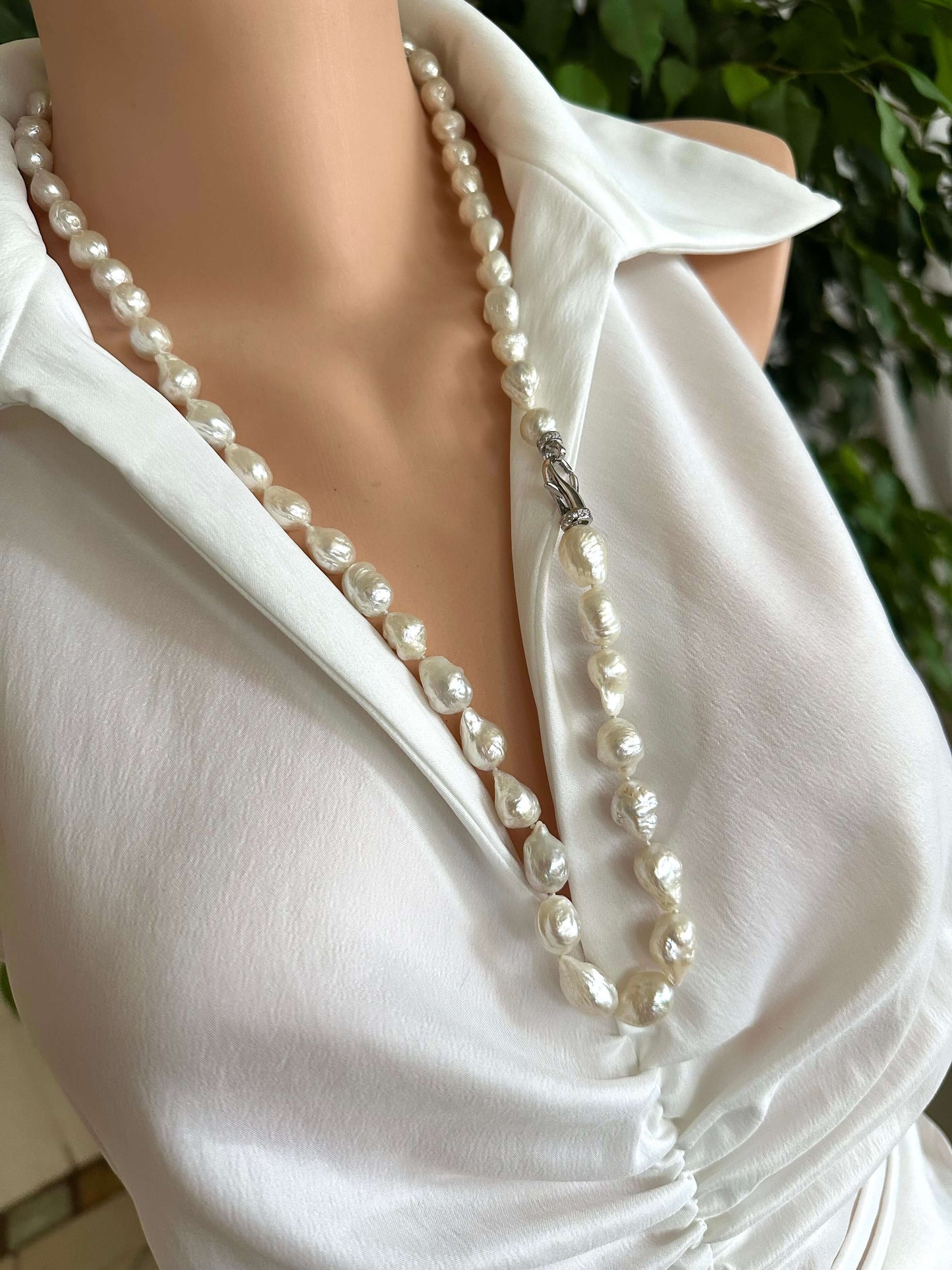 Edison baroque pearl Y necklace showcased on a mannequin, featuring hand knotted pearls and a rhodium clasp, stylishly draped.