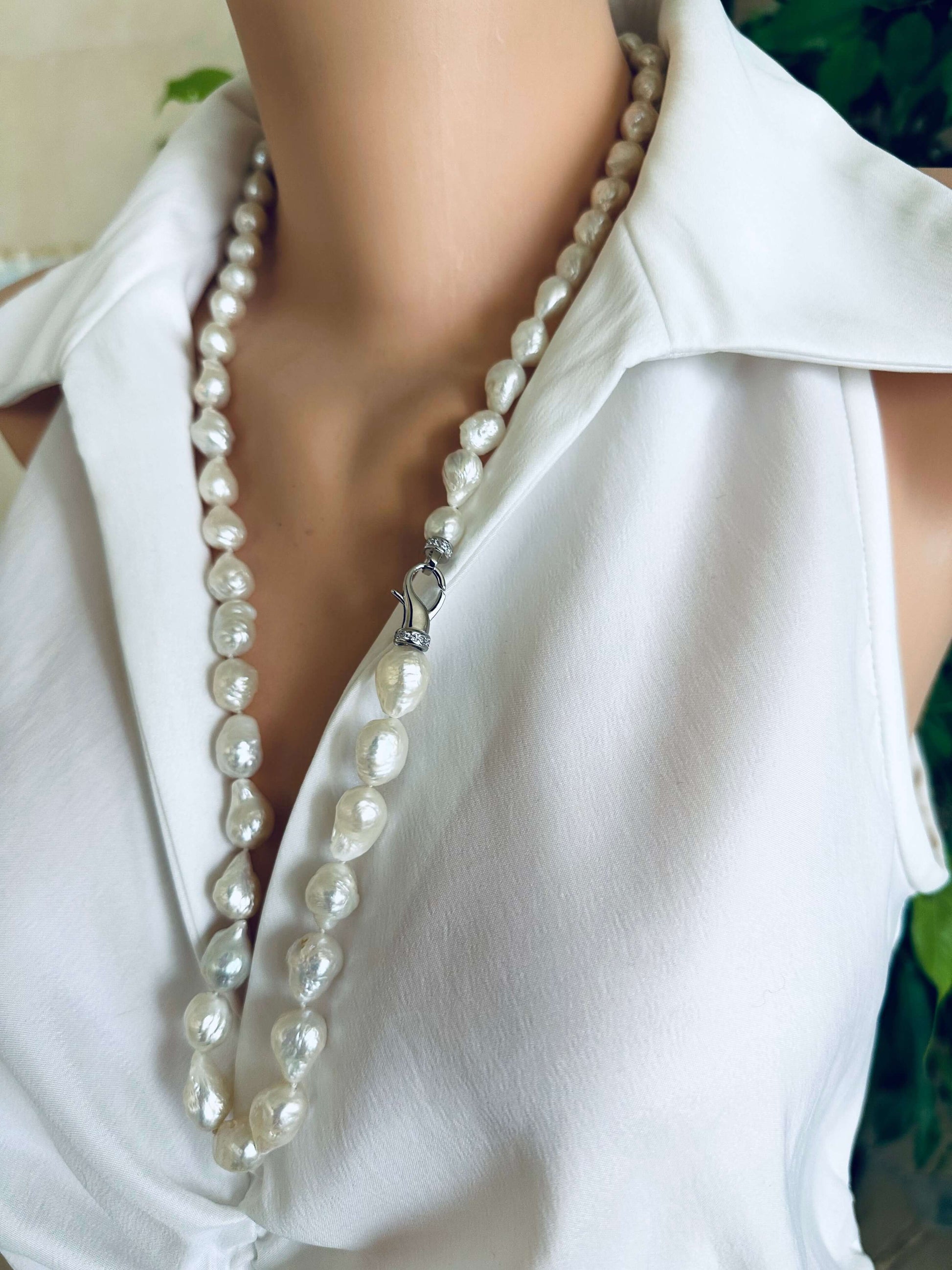 Edison baroque pearl Y necklace showcased on mannequin, featuring hand knotted white avocado pearls and rhodium clasp.