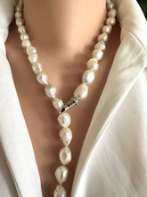 Lade das Bild in den Galerie-Viewer, Edison Pearl necklace worn by a person in a white outfit. pearls are baoque and hand knotted
