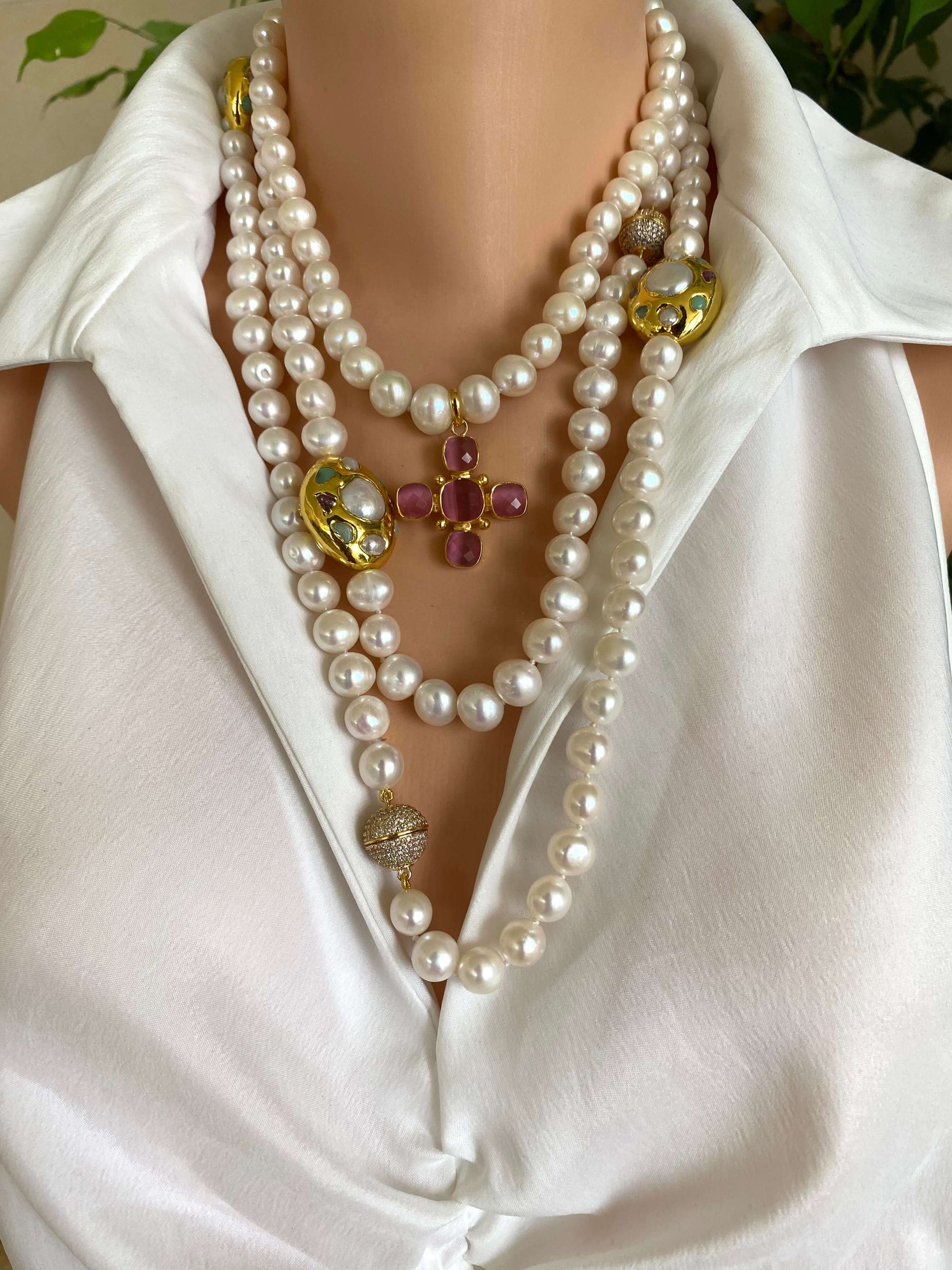 White potato pearl necklace with cross pendant displayed on a mannequin, showcasing its elegance and shine.