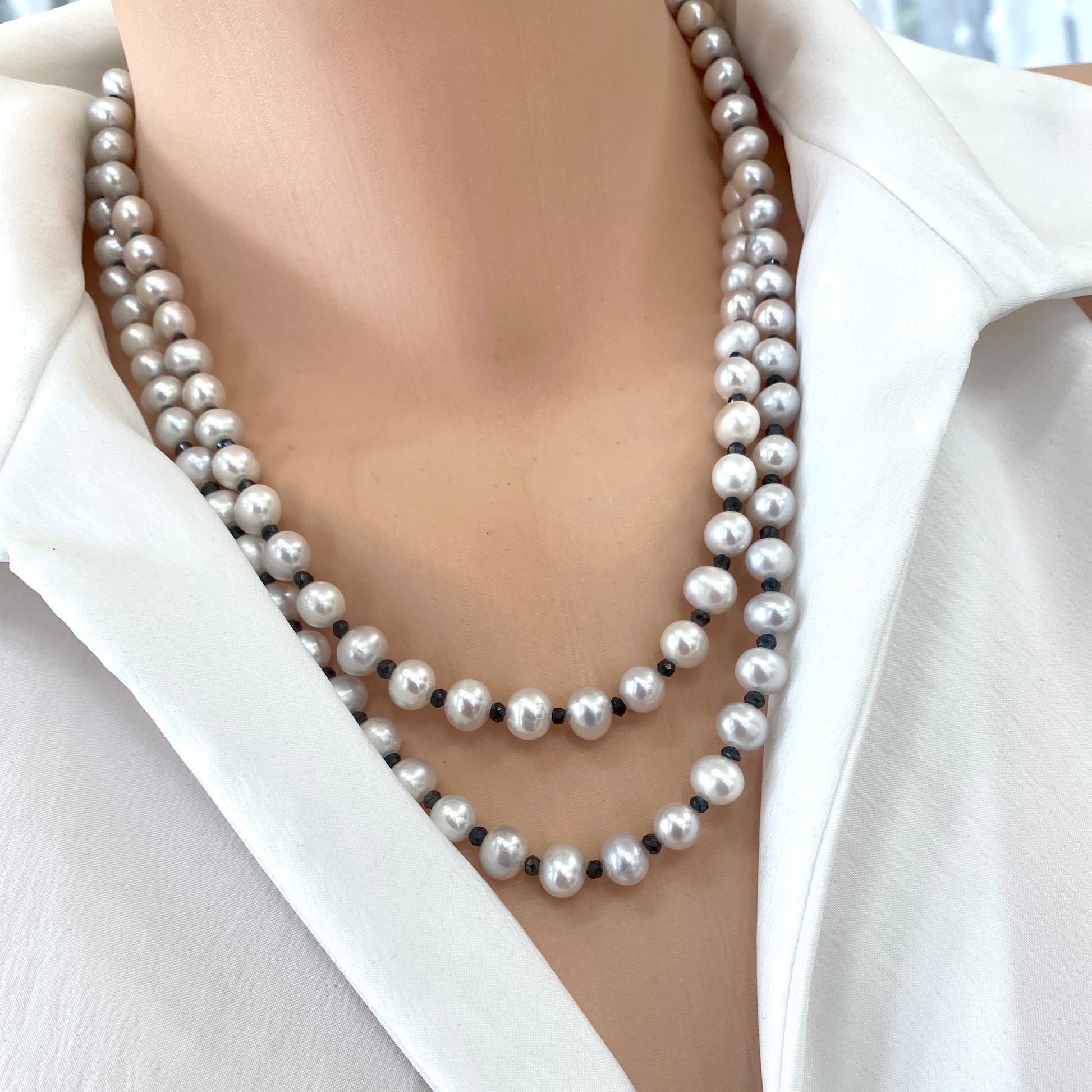 Light grey freshwater pearl necklace – Long silver & spinel design with layered pearls shown on a model.