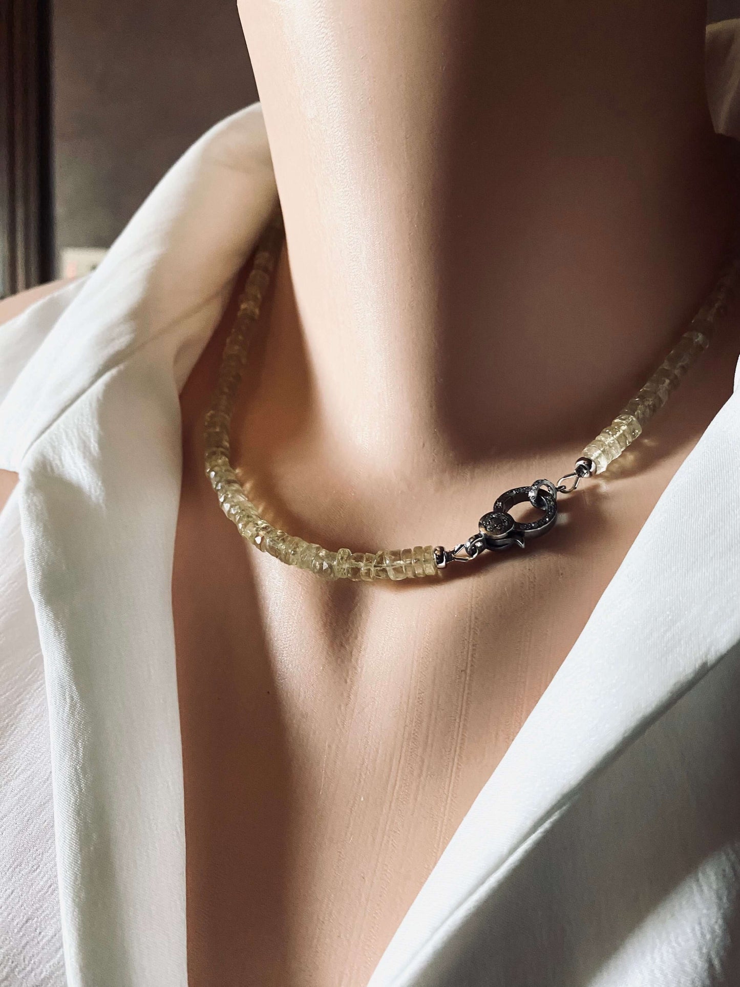 Lemon quartz beaded necklace with oxidized silver pavé clasp displayed elegantly on a mannequin.