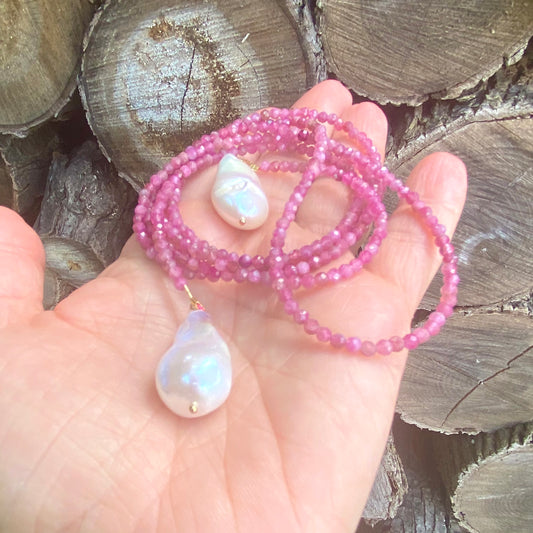 Pink Tourmaline Pearl Lariat Necklace displayed in hand, featuring pink tourmaline beads and baroque pearls.
