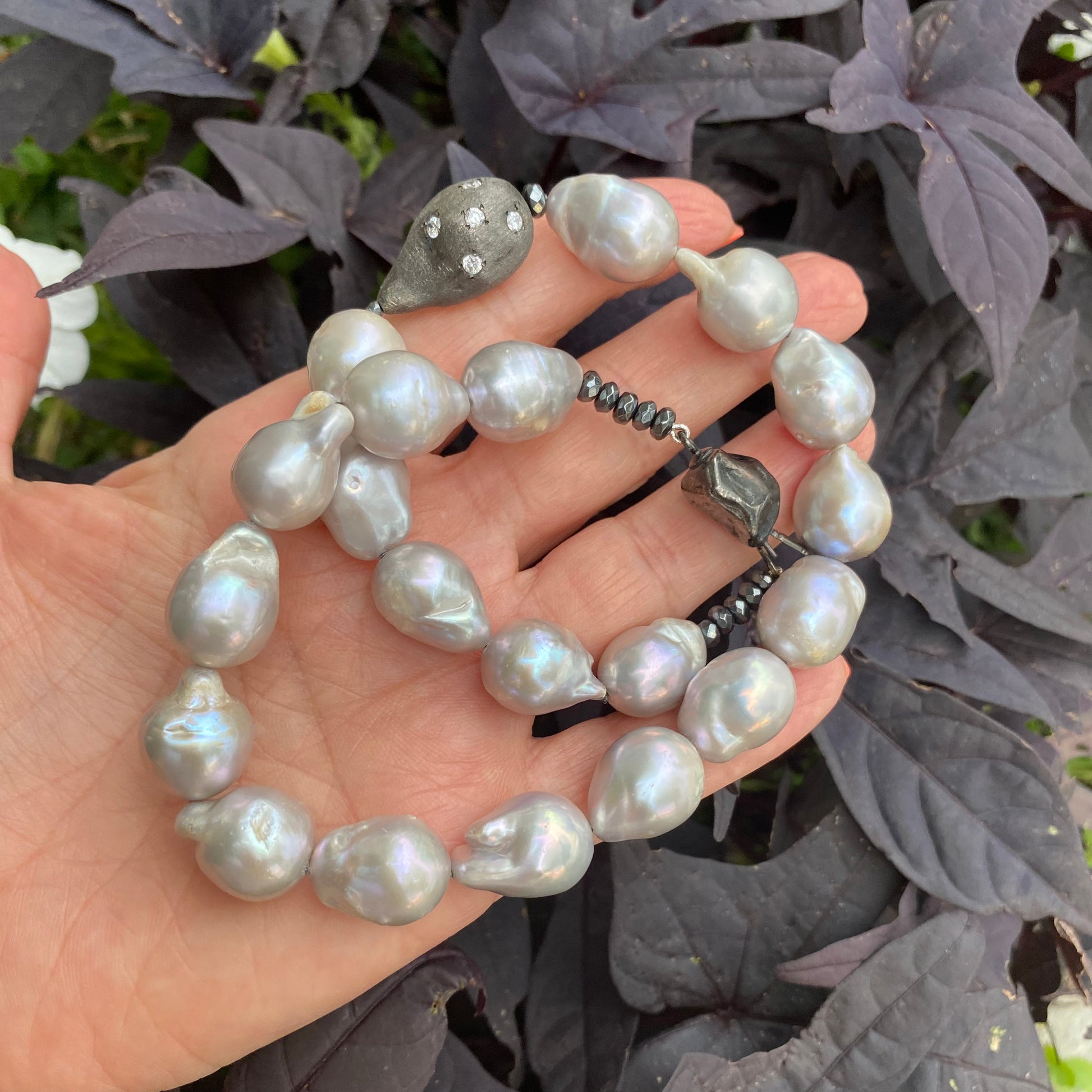 Grey Baroque Pearl Choker Necklace – Baroque-Inspired Statement Piece held in hand.